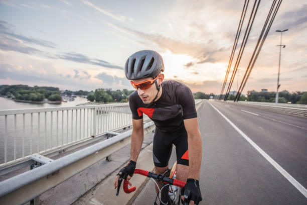 istock Athlete riding bicycle on the road 1199664701