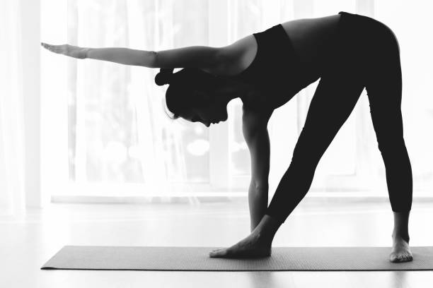 istock Sporty woman practicing yoga, doing triangle asana 1199664844