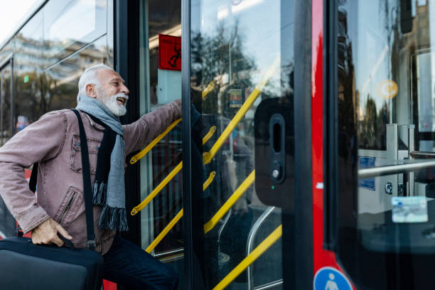 istock Senior Business Man Using Public Transportation - Bus 1199665237