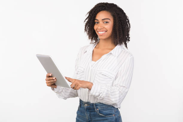 istock Smiling black girl standing with tablet at studio 1199665353