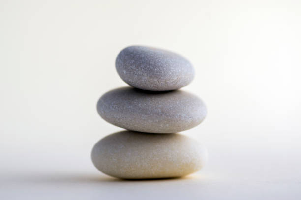 istock Harmony and balance stack of smooth white pebbles on light background 1199665996