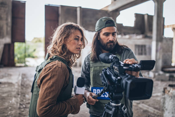 istock Man and woman war press in abandoned building 1199666556