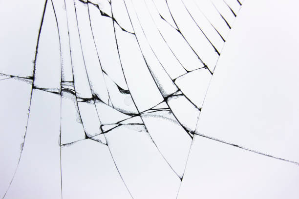 istock Cracked broken glass in window on light gray background. Cracks concept for design. 1199666586