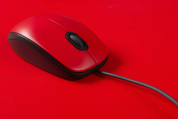 red mouse with cable close up on a red background