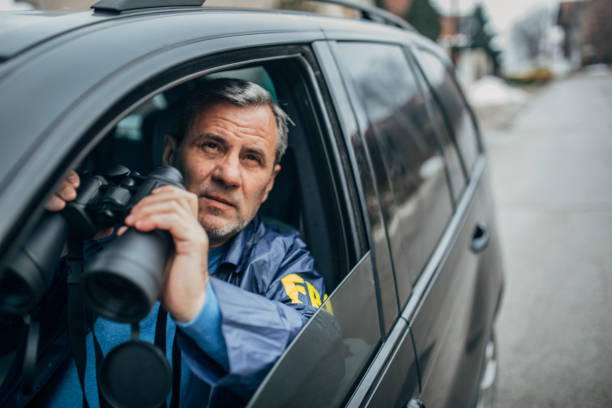 istock An FBI agent with his binoculars spying on his car 1199667858