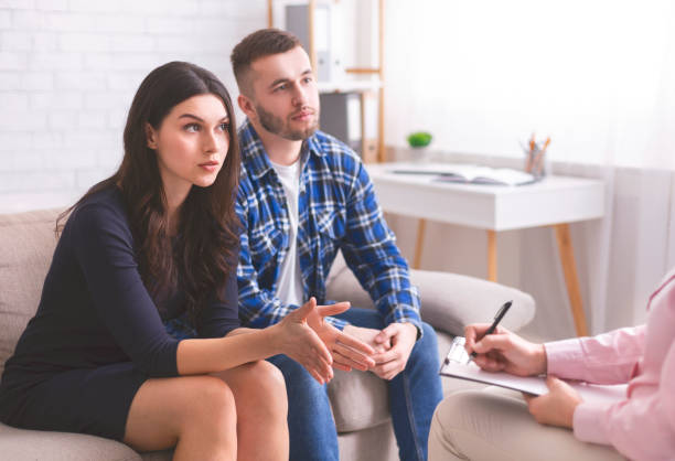 istock Irritated couple discussing their problems at marital therapy 1199667972