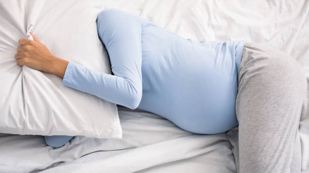national sleep foundation Pregant lady sleeping and covering head with pillow Pregant lady sleeping and covering head with pillow, suffering from insomnia pregnancy insomnia stock pictures, royalty-free photos & images