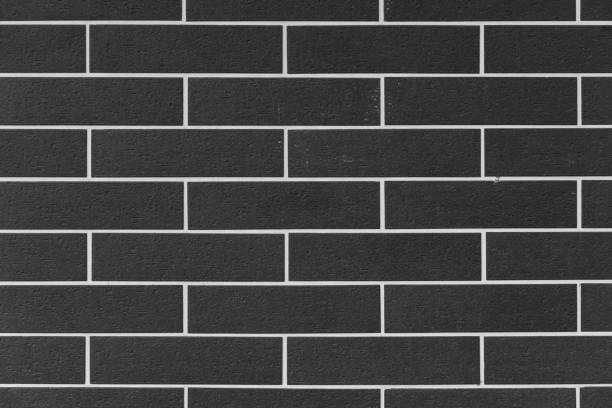 istock brick wall with black bricks and white filling at square format as background and texture 1199668579