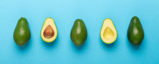 istock Eco disposable single up cutlery with avocado seeds on blue 1199669771