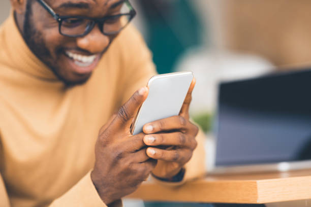 istock Shocked afro guy excited with unexpected online lottery win 1199670406