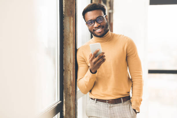 istock Successful afro man standing near window at office 1199671680