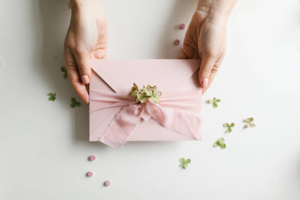 istock Beautiful light pink holiday card in envelope 1199671739