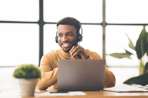 istock Happy black manager working in call centre 1199671779