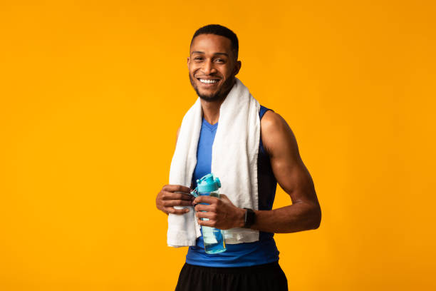 istock Handsome afro sportsman holding water bottle copyspace 1199672081