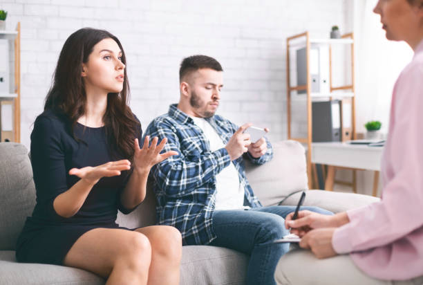 istock Husband networking on cellphone during marital therapy 1199672210