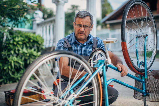 istock Senior men repair bicycle 1199672925