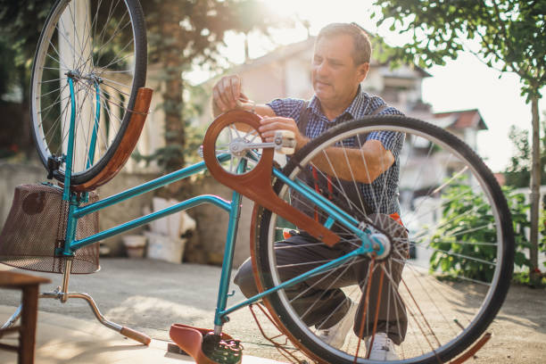 istock Senior man repair bicycle 1199673017