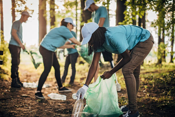 istock Volunteers with garbage bags cleaning park area 1199673405
