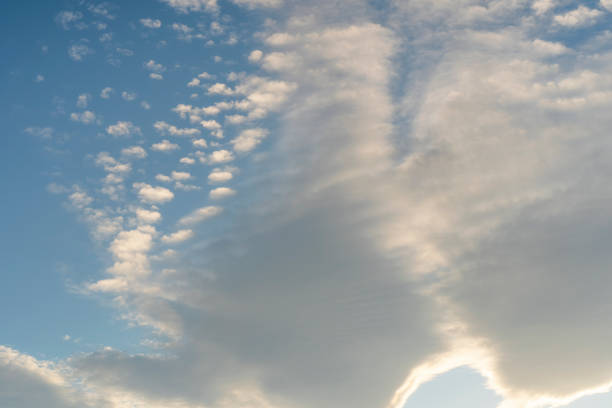 istock Beautiful cirrus and cumulus clouds on a bright blue sky lit by sunlight 1199673833