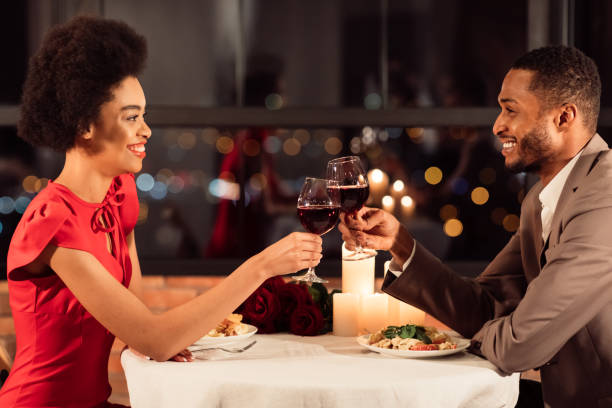 istock Joyful Couple Clinking Glasses Drinking Red Wine Sitting In Restaurant 1199674595