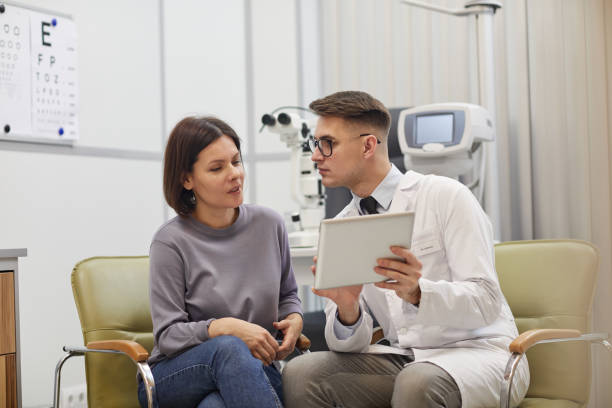 istock Young Woman Talking to Ophthalmologist 1199676265