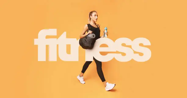 Photo of Big fitness inscription over girl going to gym
