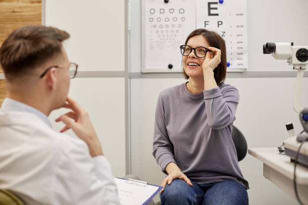 istock Smiling Young Woman Trying On New Glasses 1199676331
