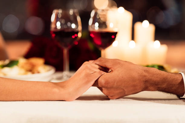 istock Unrecognizable Couple Holding Hands On Served Restaurant Table Background, Closeup 1199676399