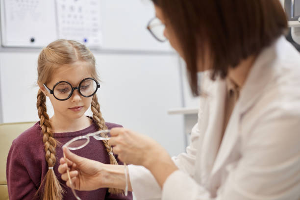 istock Little Girl Choosing Glasses 1199676442