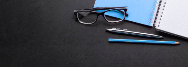 istock Office desk with notepad and supplies 1199676783