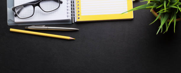 istock Office desk with notepad and supplies 1199676812