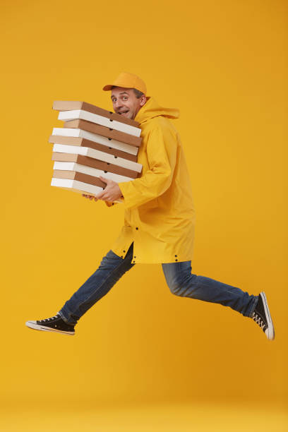 istock Pizza Delivery Guy Jumping on Yellow 1199676899