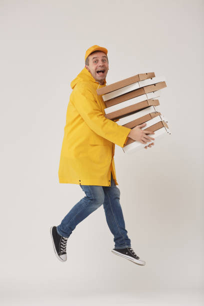 istock Joyful Pizza Delivery Guy Jumping 1199676916