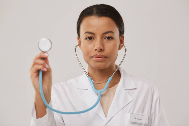 istock Female Doctor Holding Sthethoscope Posing on White 1199676942