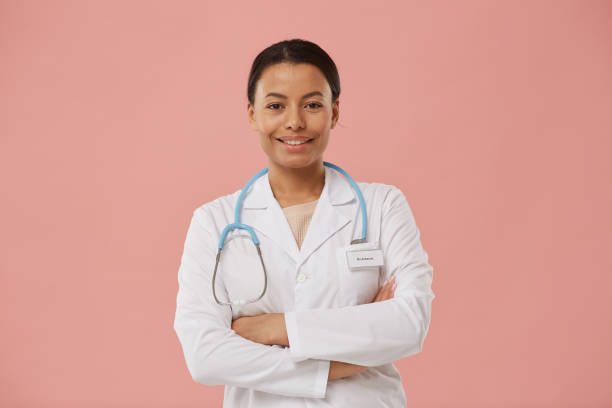 istock Smiling Female Doctor Posing on Pink 1199676957