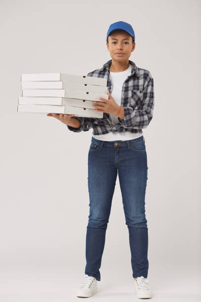 istock Pretty Young Woman Holding Pizza Boxes 1199676990