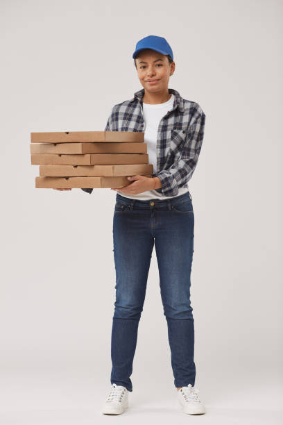 istock Young Woman Delivering Pizza 1199677006