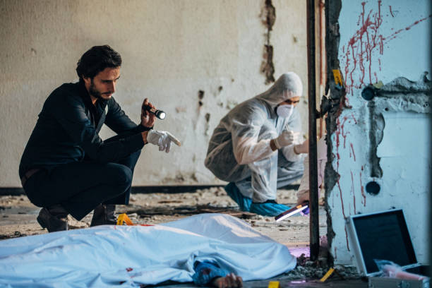 istock Detective and forensics working together at the murder scene 1199677102