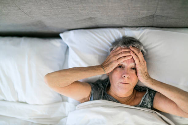 istock Senior aged woman on bed at home feeling sad 1199677119
