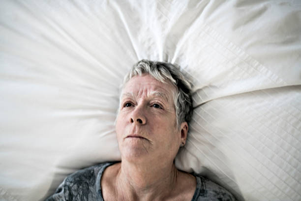 istock Senior aged woman on bed at home feeling sad 1199677150