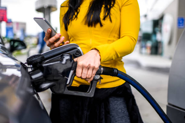 Filling a car with gas at a station stock photo