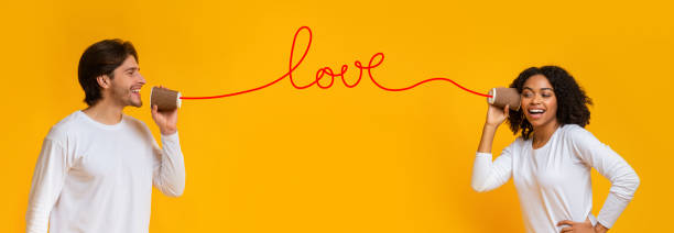 istock Loving interracial couple talking on tin phone, sending love message 1199678269