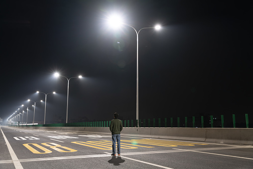 One man standing at empty highway