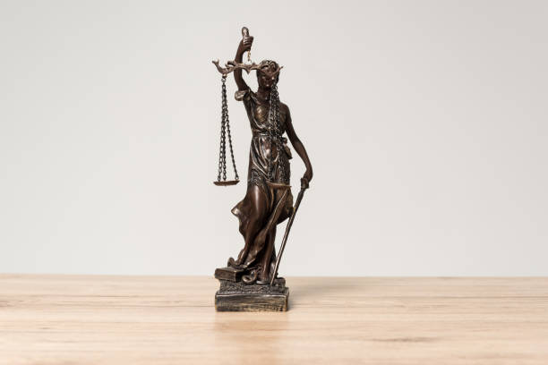 istock themis statue on wooden desk isolated on grey 1199678731