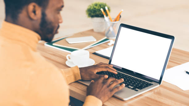 istock Afro businessman writing financial report on computer 1199678777