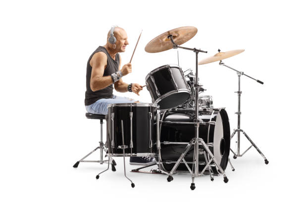 istock Male bald drummer with headphones playing drums 1199678781