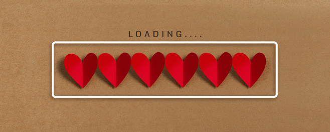 Loading progress bar with red hearts on brown paper background. Valentine's day, Love, Life concepts.