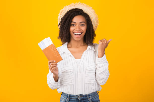 istock Afro woman showing boarding pass and passport 1199679430