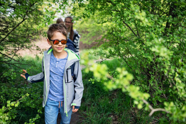 istock Family hiking in beautiful spring forest 1199679575