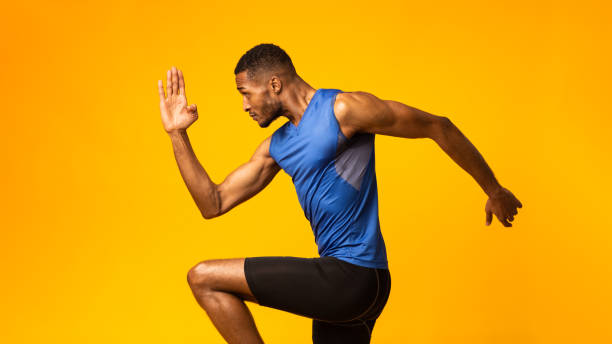 istock Handsome afro sportsman walks highly lifting knees 1199680118